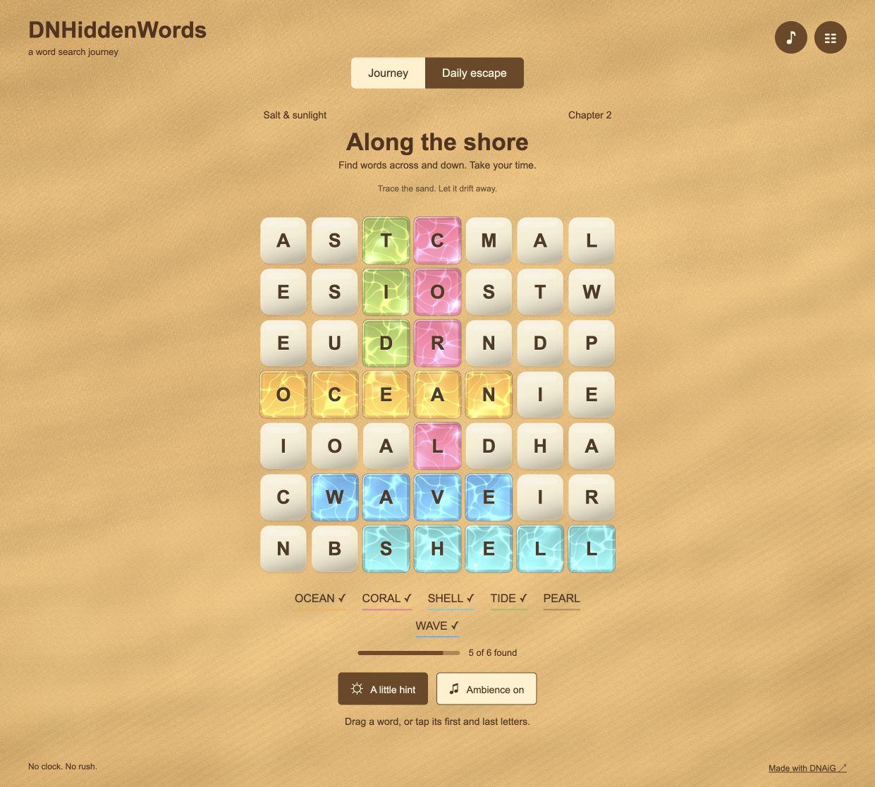 DNHiddenWords letter grid above a sand-colored playfield